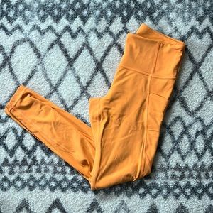 Athleta orange leggings with side pockets
